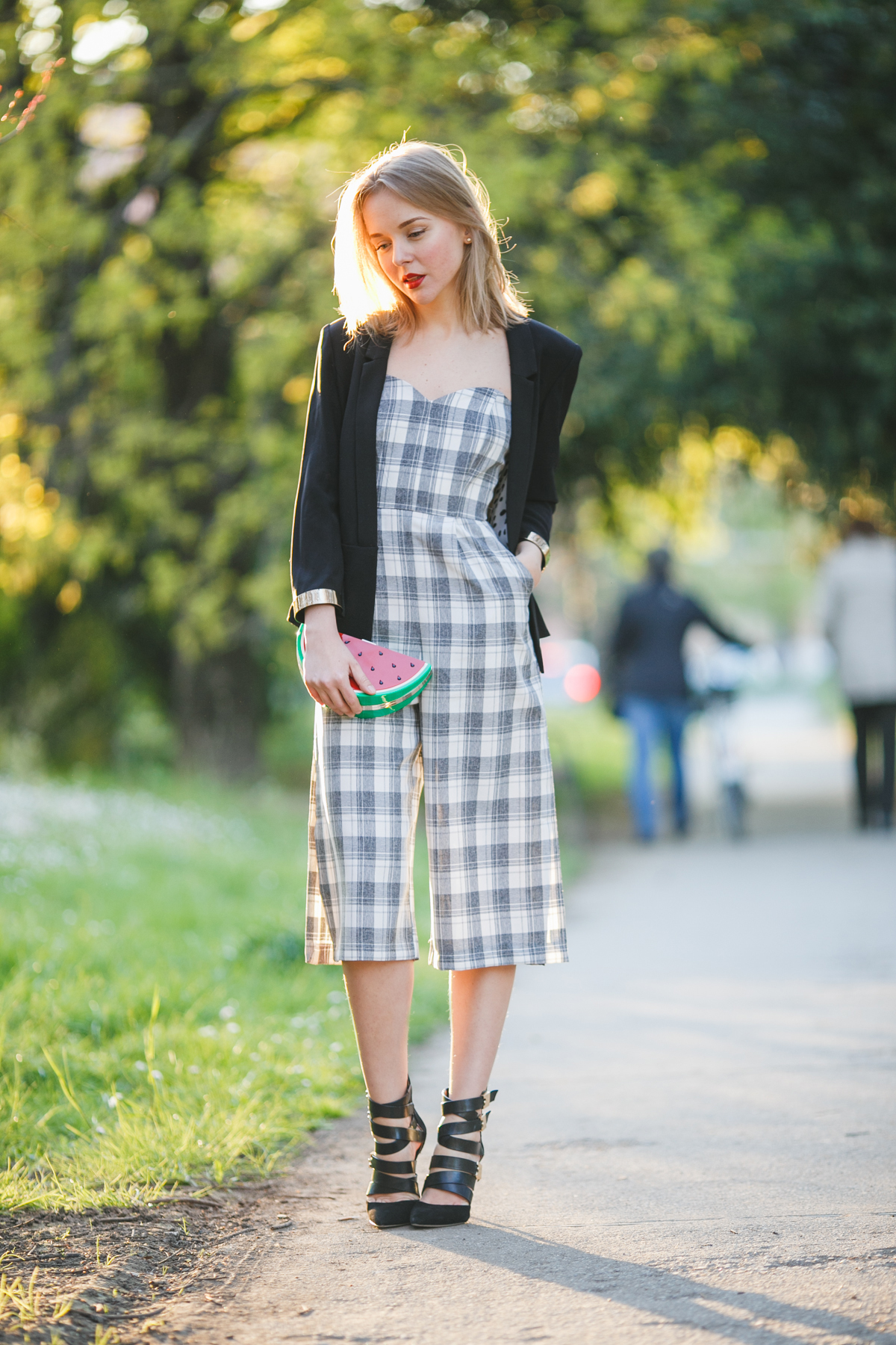 darya kamalova thecablook fashion lifestyle russian italian blogger wears lulus strapless jumpsuit with watermelon plastic clutch and guess by marciano black jacket and booties-16